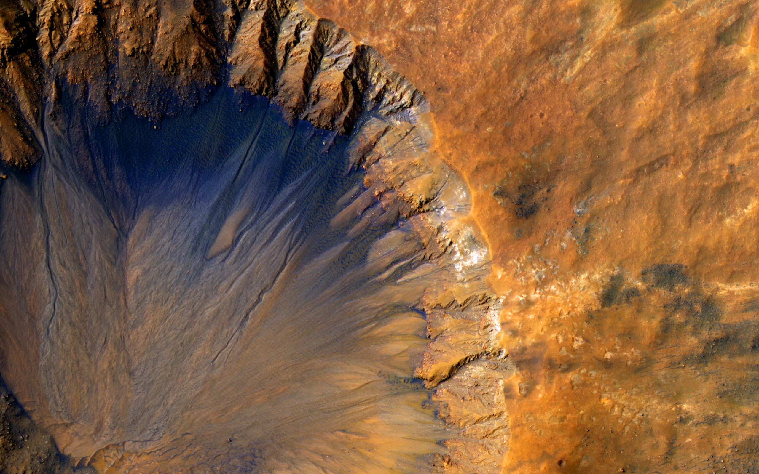 A satellite photo of the Sirenum Fossae, a large trough on the surface of Mars.